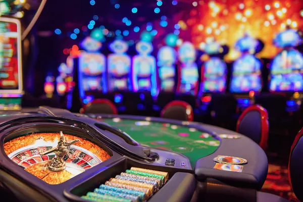 A man celebrating a winning moment on his laptop while gaming symbols float around him, capturing the excitement of GOOD11111 games.